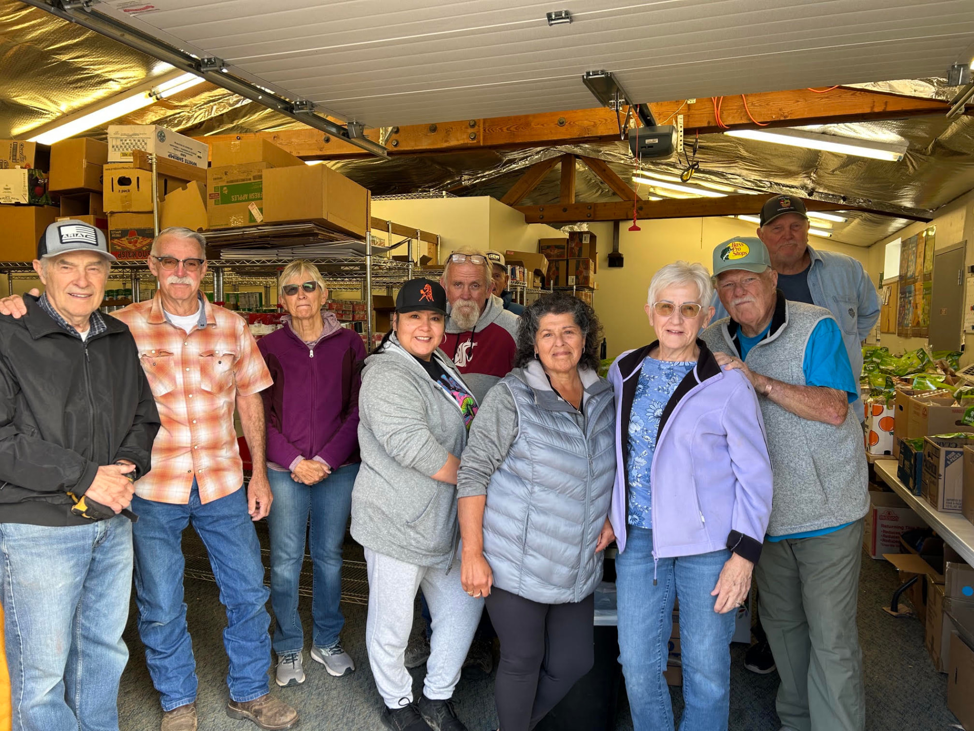The Brewster Food Pantry volunteer team gathered together inside the pantry